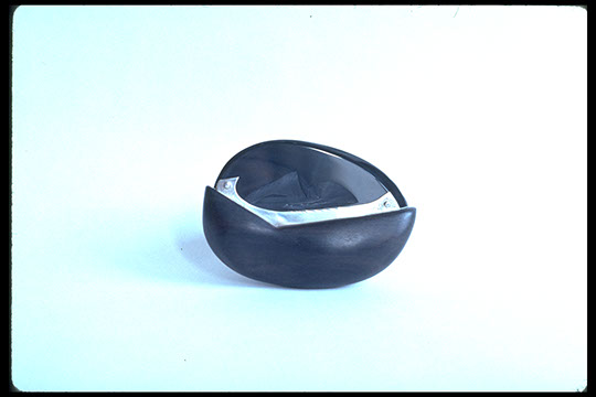 Black Obsidian cut in round knife shape, set in sterling silver, and handle of ebony. The 4 elements; earth, fire, air, water are represented . 